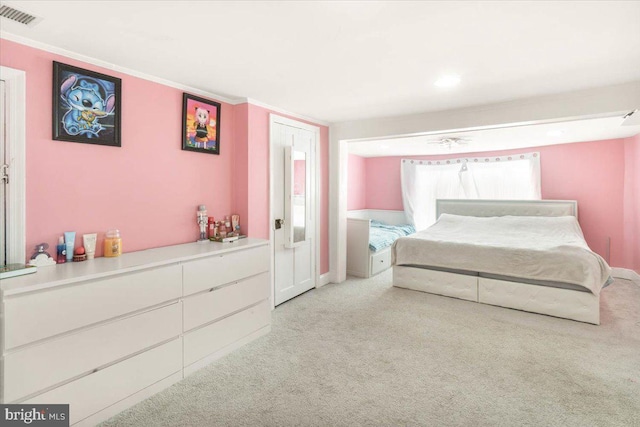 bedroom featuring light colored carpet and ornamental molding