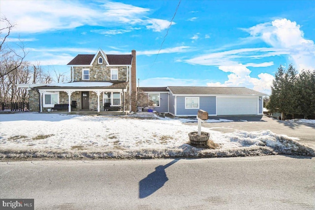 view of front of house with covered porch and a garage