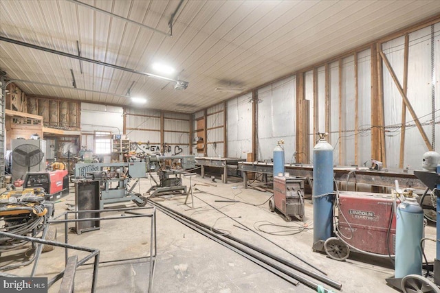 miscellaneous room featuring concrete floors and a workshop area