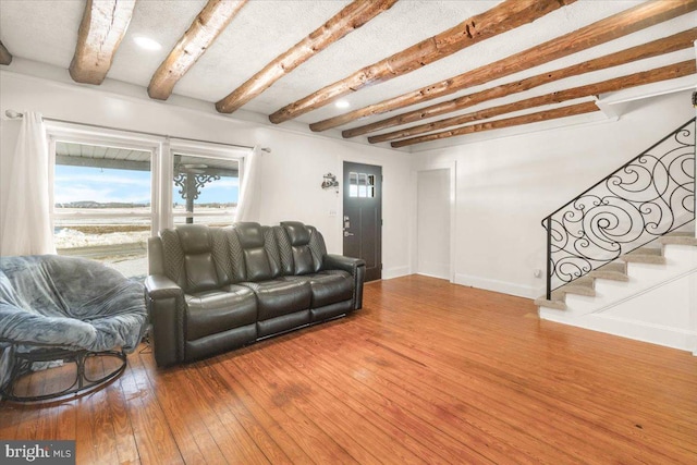 living room with beam ceiling and hardwood / wood-style flooring