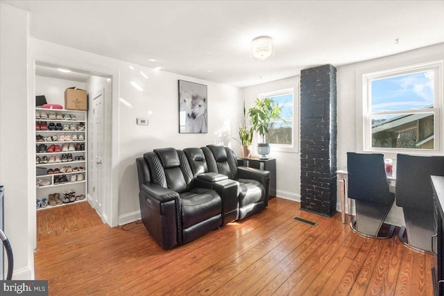 living room with a wealth of natural light and hardwood / wood-style flooring