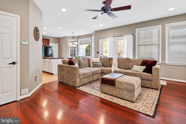 living room featuring hardwood / wood-style floors and ceiling fan