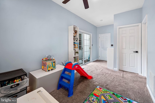 recreation room with carpet floors and ceiling fan