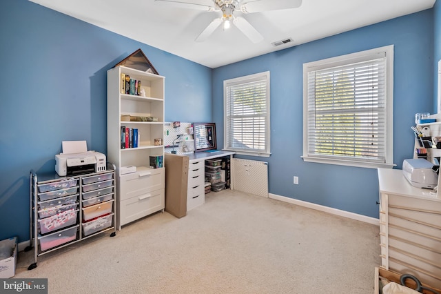 office with light carpet and ceiling fan