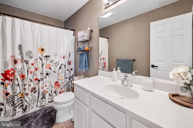 bathroom with vanity, tile patterned flooring, and toilet