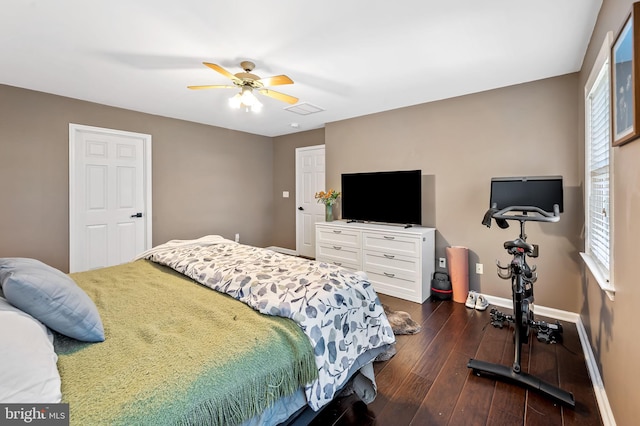 bedroom with ceiling fan and dark hardwood / wood-style floors