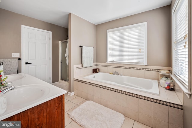 bathroom featuring tile patterned flooring, plus walk in shower, and vanity