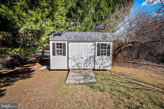 view of outbuilding with a lawn