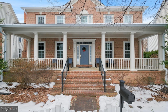 view of front of property featuring a porch and brick siding