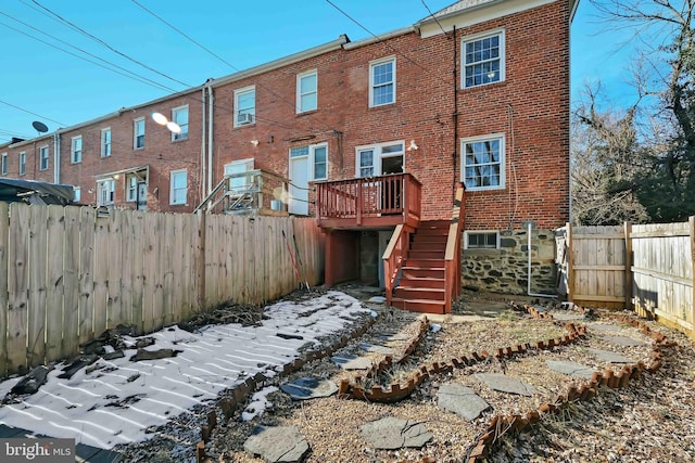 view of snow covered back of property