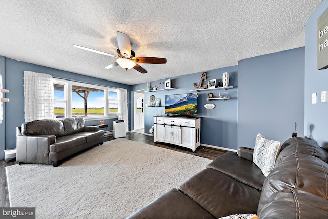 living room featuring a textured ceiling, ceiling fan, and dark hardwood / wood-style floors