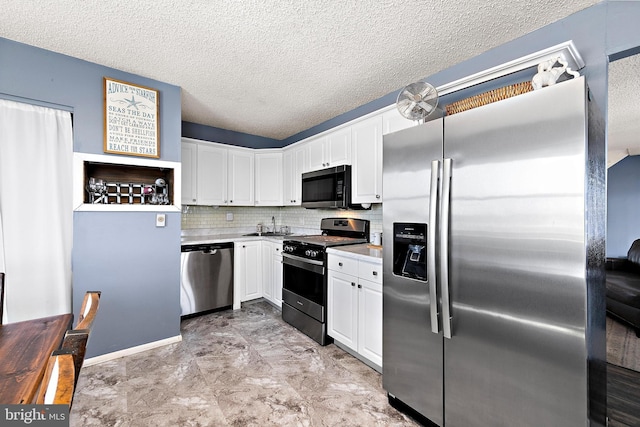 kitchen featuring a textured ceiling, white cabinetry, stainless steel appliances, sink, and backsplash