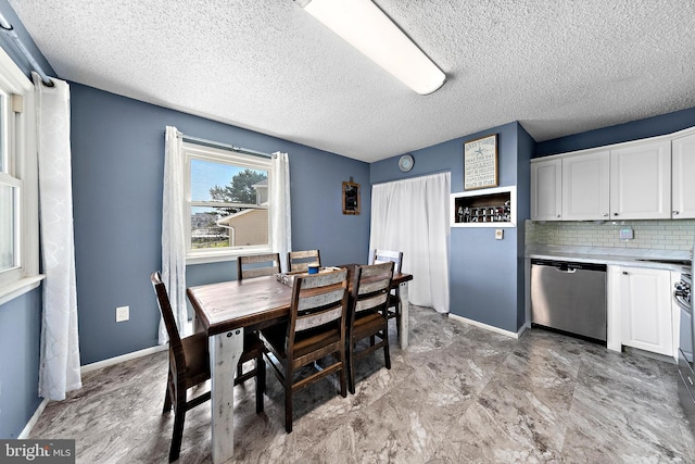 dining space with a textured ceiling