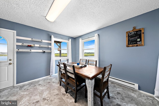 dining space featuring a water view, baseboard heating, and a textured ceiling