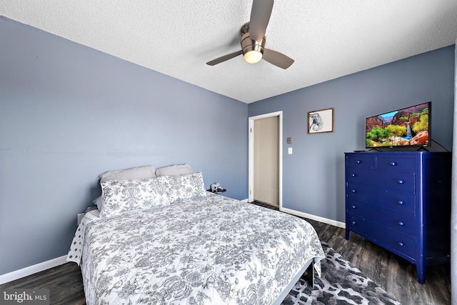 bedroom featuring ceiling fan, dark wood-type flooring, and a textured ceiling