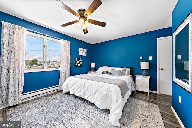 bedroom featuring a baseboard heating unit, ceiling fan, and dark hardwood / wood-style flooring