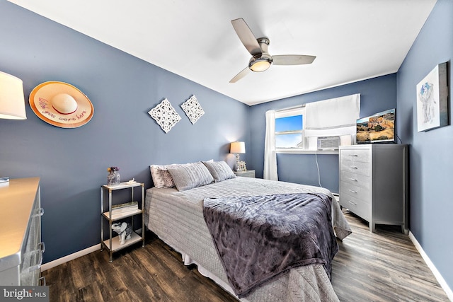 bedroom featuring ceiling fan, cooling unit, and dark hardwood / wood-style floors