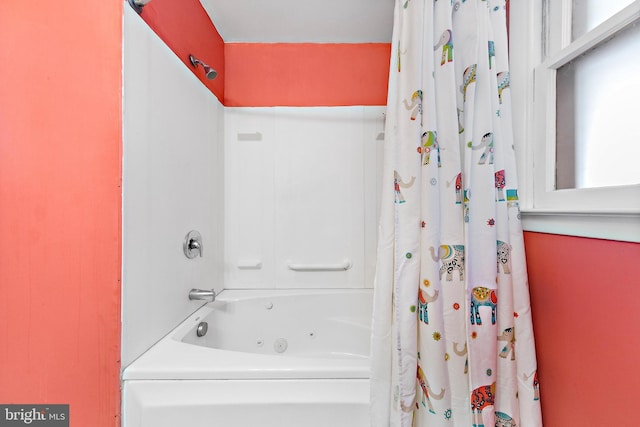 bathroom with shower / bath combo with shower curtain