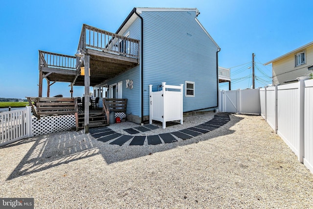 back of house with a wooden deck