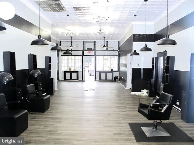 exercise room with a towering ceiling and hardwood / wood-style floors