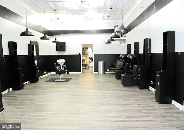 gym featuring a towering ceiling and light hardwood / wood-style flooring