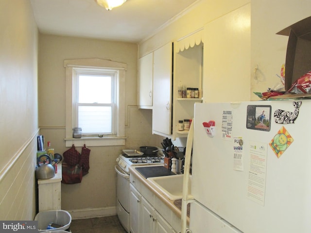 kitchen with white appliances and white cabinetry