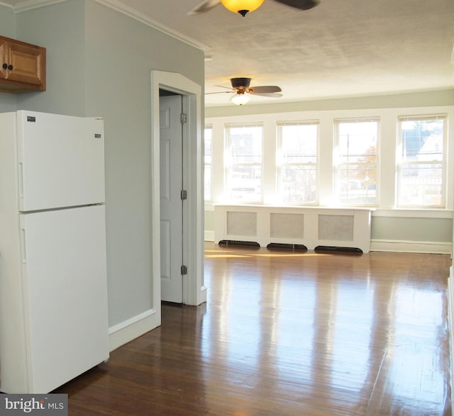 interior space featuring hardwood / wood-style flooring, ceiling fan, and crown molding