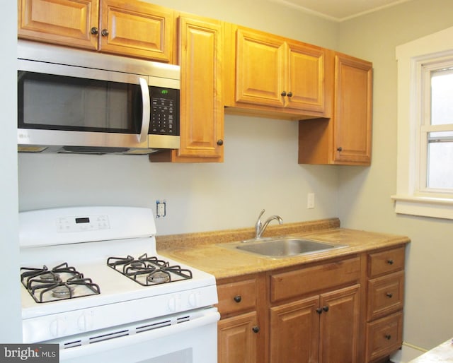 kitchen featuring sink and white gas range