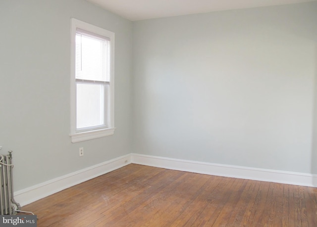 unfurnished room with wood-type flooring and a healthy amount of sunlight