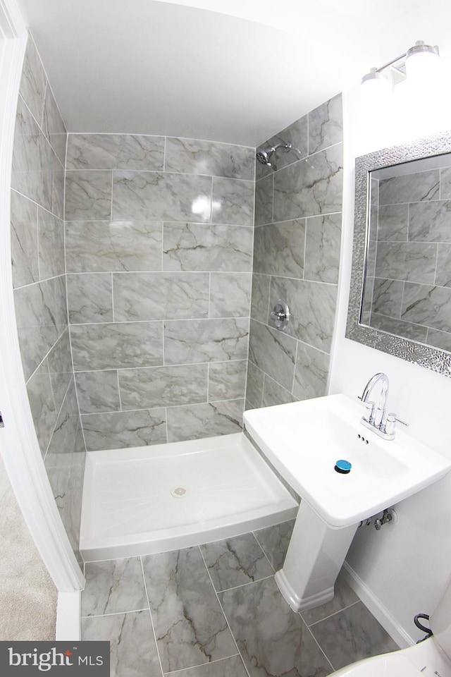 bathroom with a tile shower