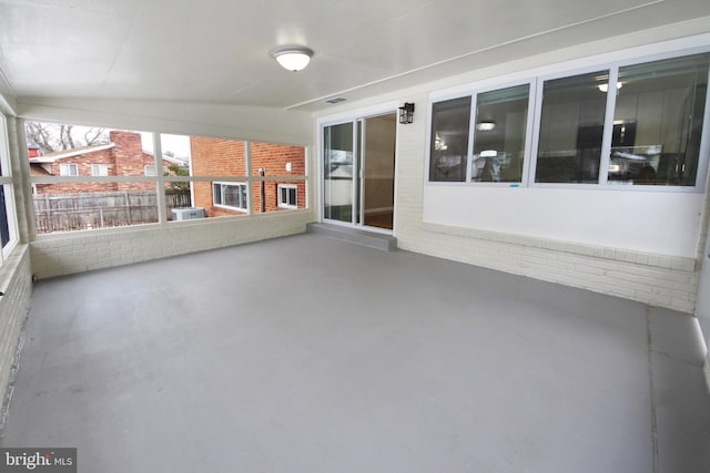 unfurnished sunroom with lofted ceiling