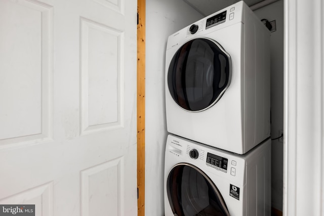 laundry room featuring laundry area and stacked washer and clothes dryer