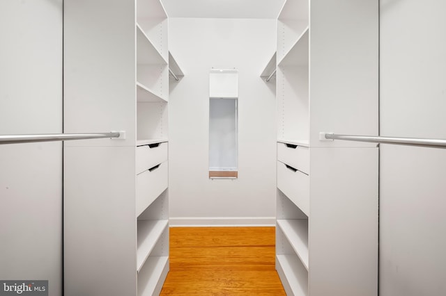 walk in closet featuring light wood-style flooring