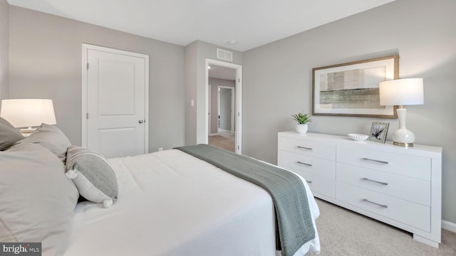 bedroom featuring light carpet