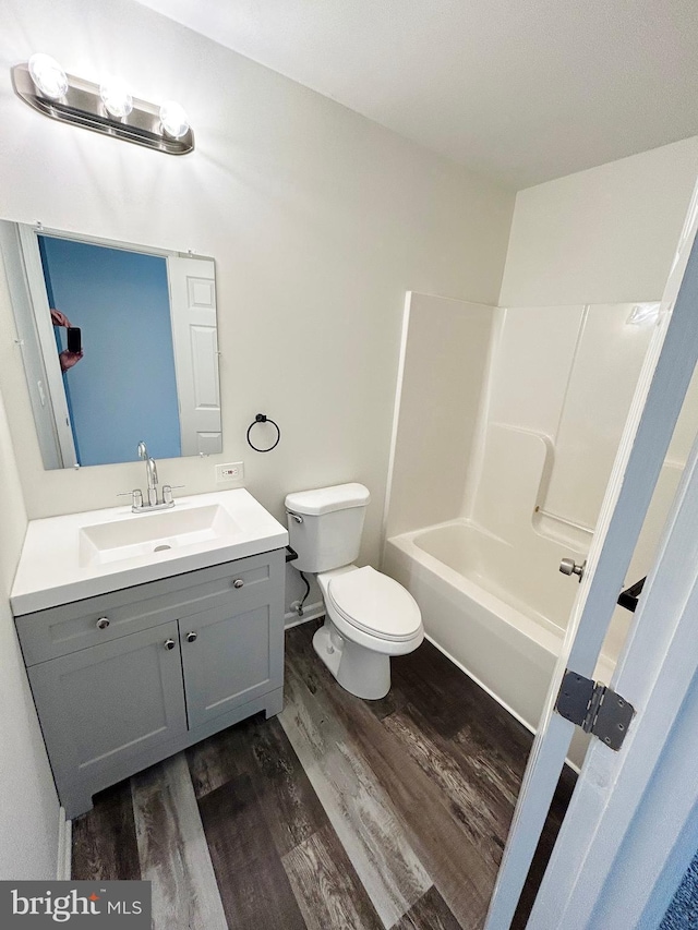 full bathroom featuring toilet, vanity, shower / bathtub combination, and wood finished floors