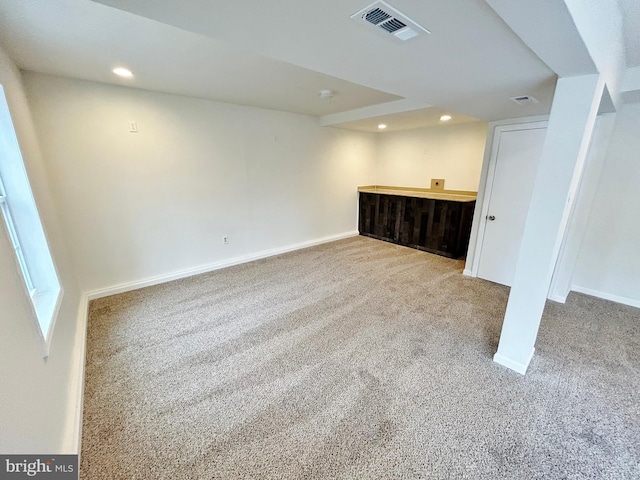 finished basement featuring visible vents, recessed lighting, baseboards, and carpet floors