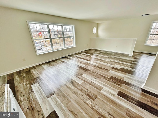 interior space with wood finished floors and baseboards