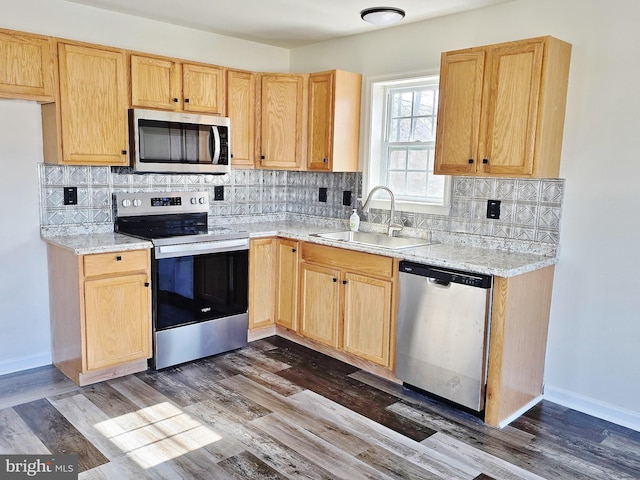 kitchen featuring a sink, stainless steel appliances, dark wood-style floors, and light brown cabinetry