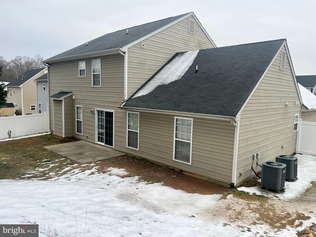 snow covered property with a patio area and cooling unit