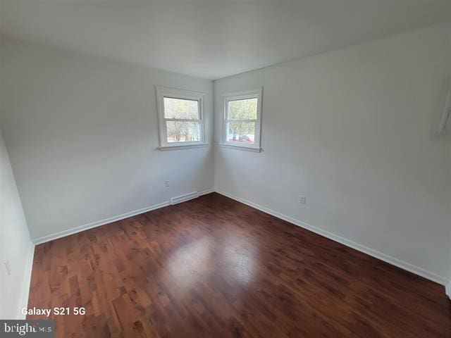 spare room featuring dark hardwood / wood-style flooring