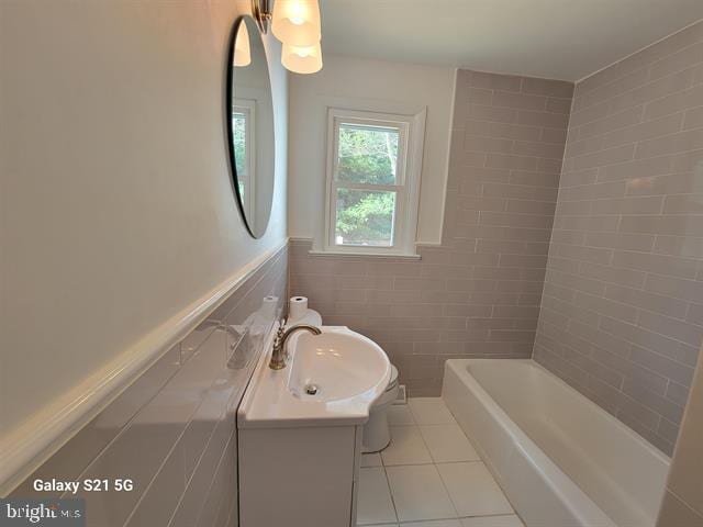 bathroom with tile walls, vanity, and tile patterned floors