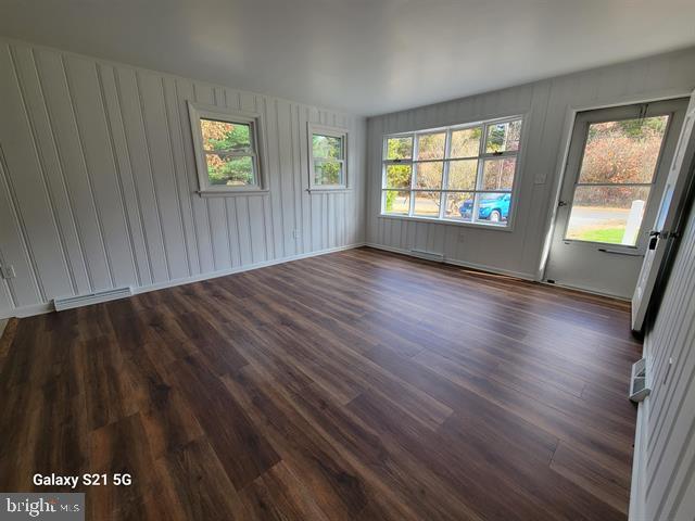 unfurnished room featuring dark hardwood / wood-style floors