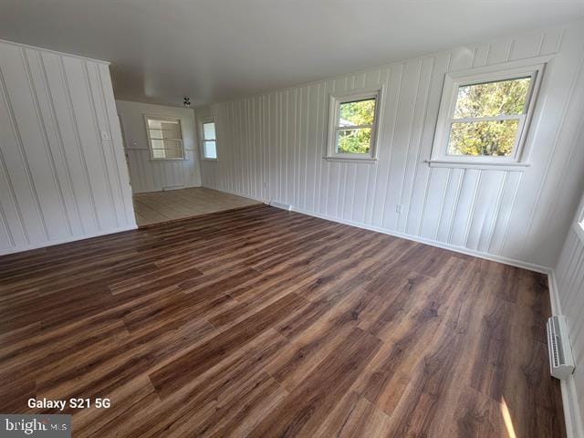 unfurnished room featuring dark wood-type flooring