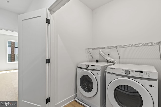 laundry room featuring washer and dryer and light wood-type flooring