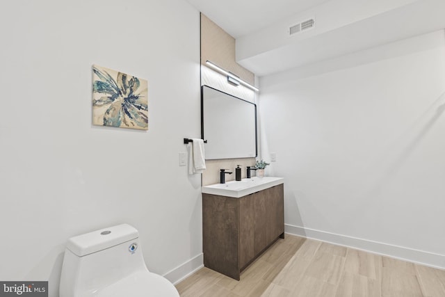 bathroom featuring toilet and vanity