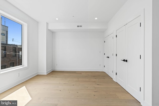 spare room featuring light wood-type flooring