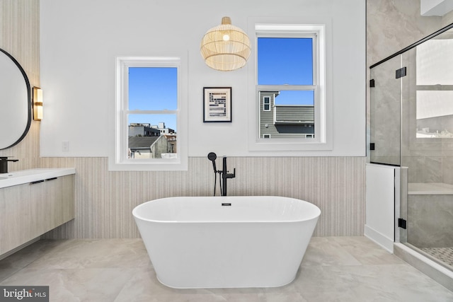 bathroom featuring shower with separate bathtub and vanity