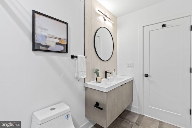 bathroom with toilet and vanity