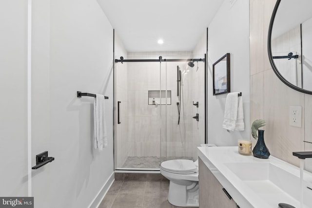 bathroom with toilet, a shower with door, and vanity