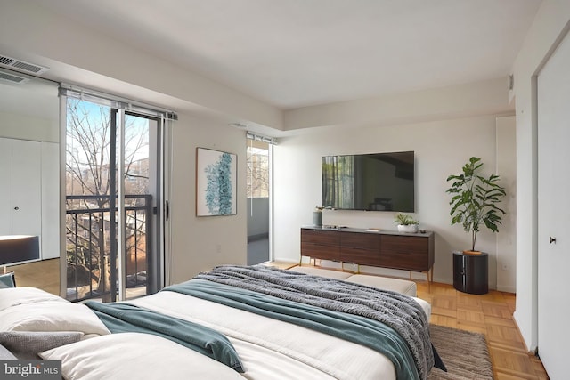 bedroom with access to exterior and light parquet floors